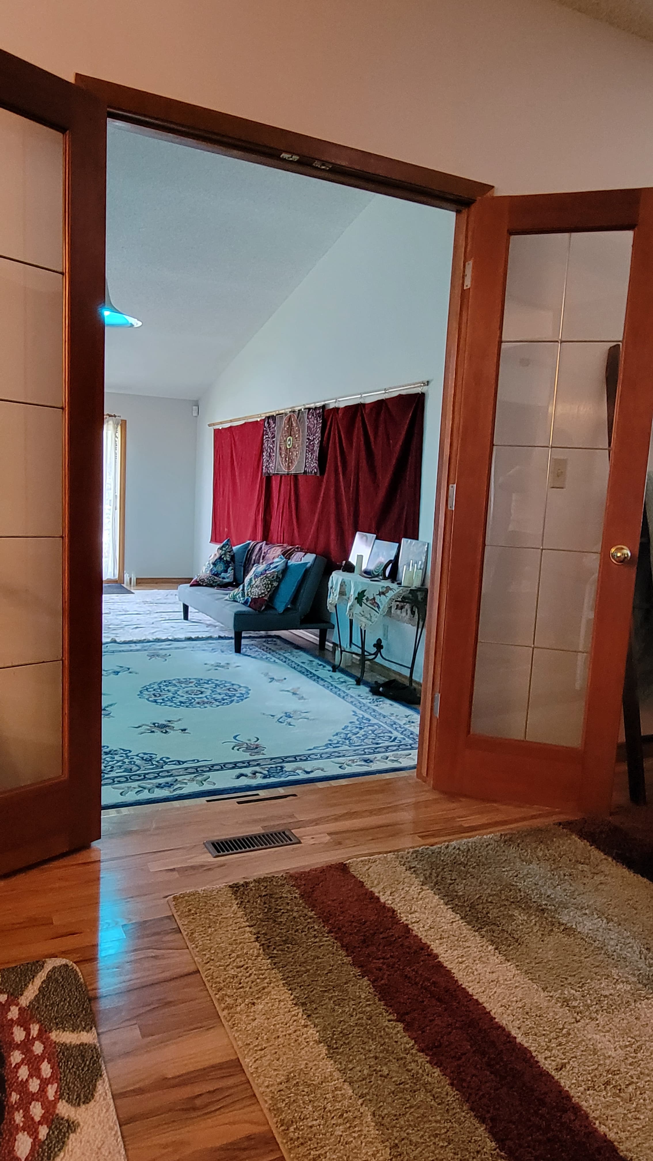 Looking through the french doors into the great room with red velvet stage curtain