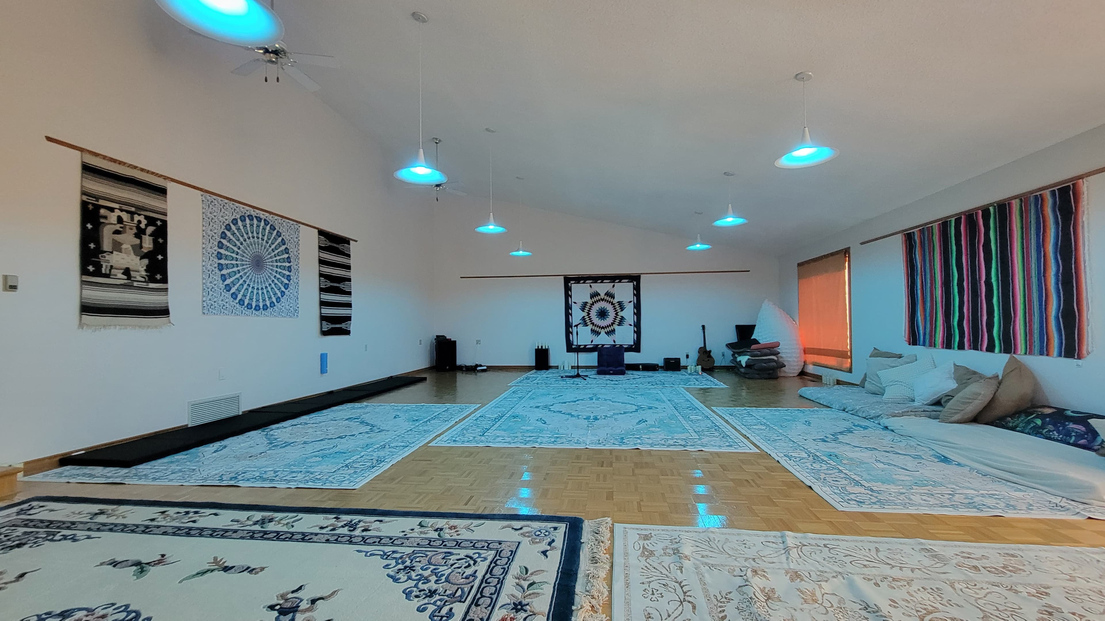 The great room at Journey Center with star quilt centerpiece, woven tapestries, and floor rugs under a vaulted ceiling