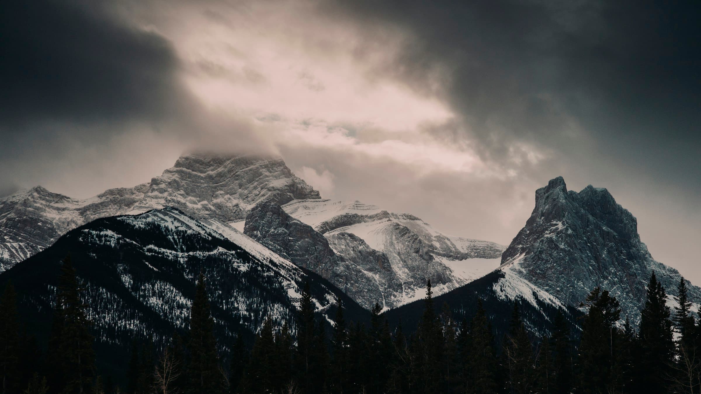 The Three Sisters in the Rocky Mountain front range under brooding cloud