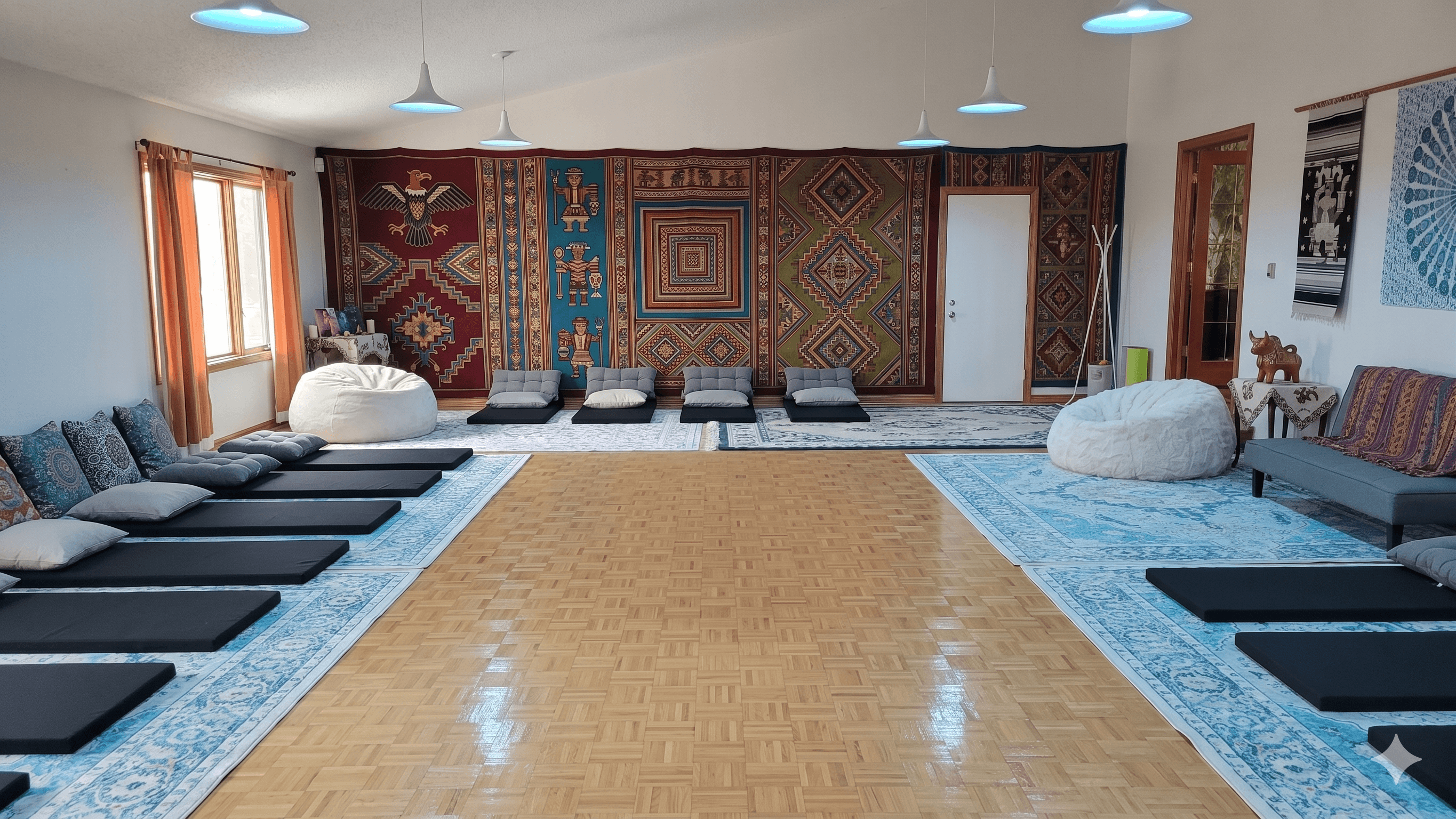 The great room set up for a workshop, mats and cushions arranged around the perimeter with an open floor at the center